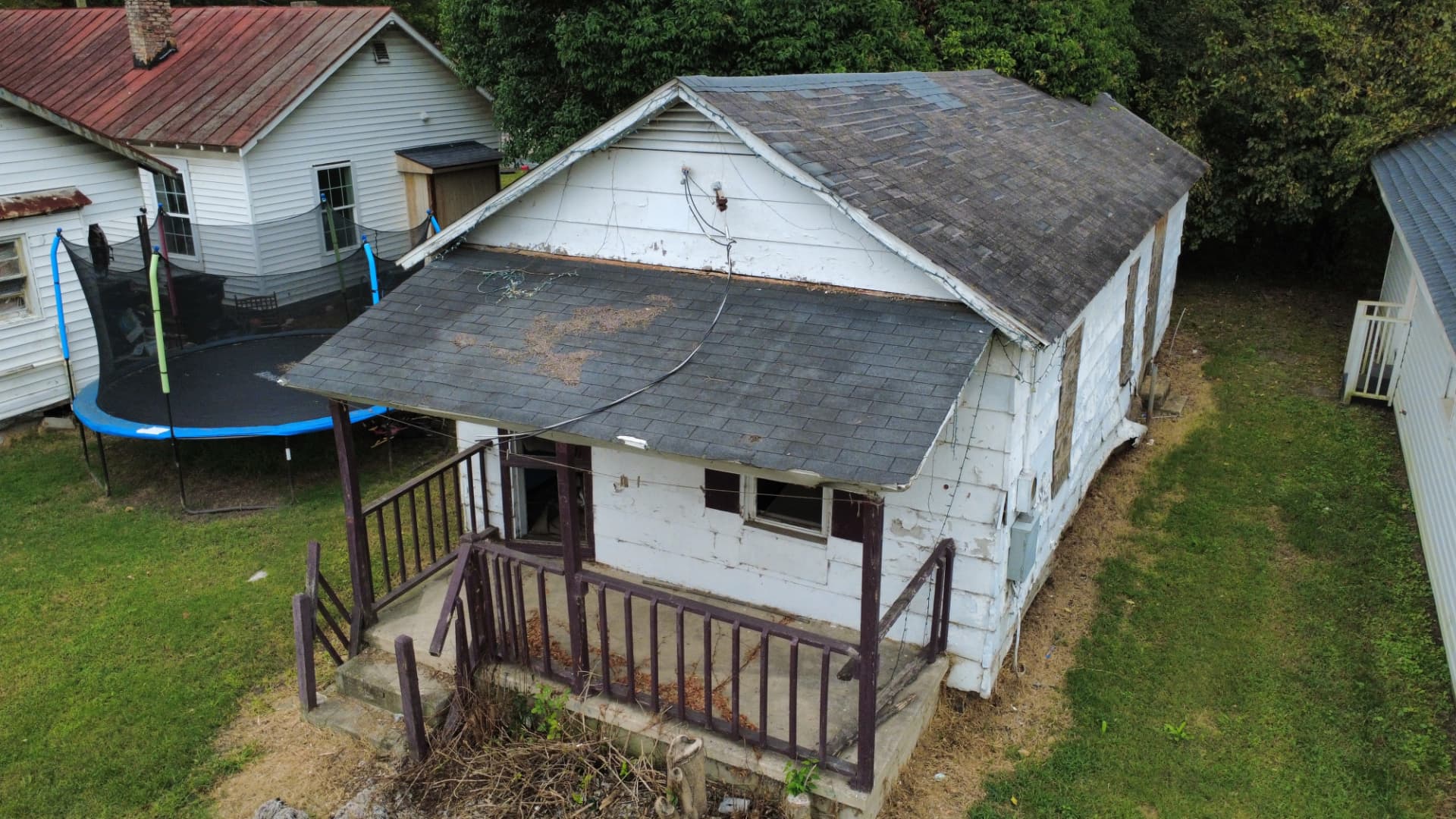 Aerial view of a weathered single-family home before demolition