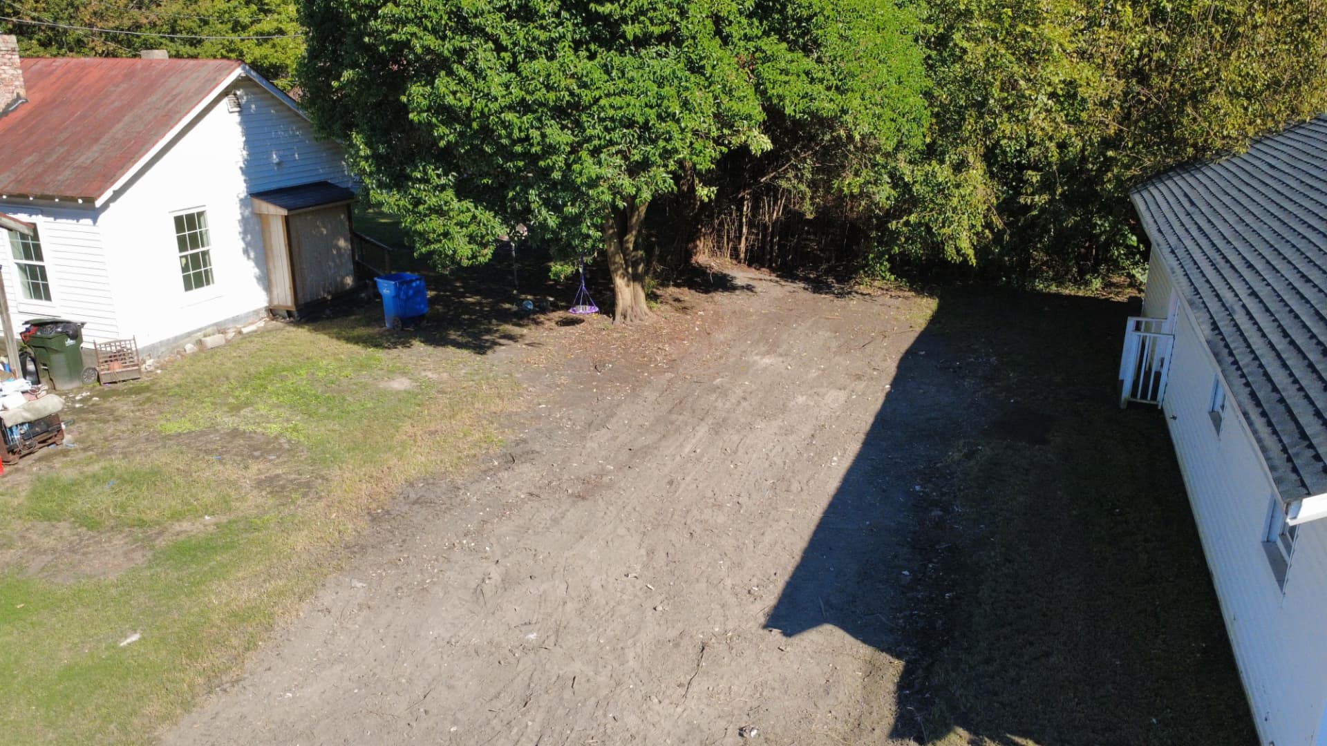 Aerial view of the same lot cleared and graded after the home was demolished