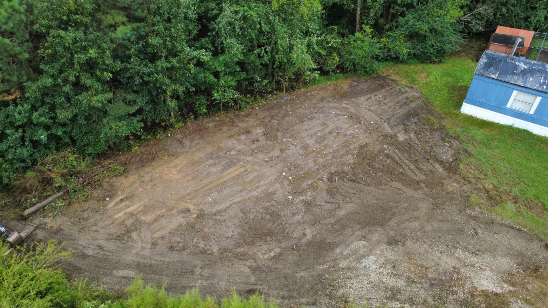 Aerial view of the same site leveled and cleared after the outbuilding was demolished